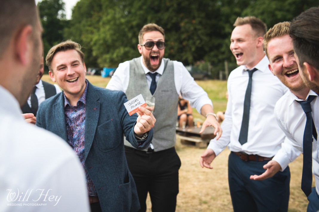 Wedding magician with a shocked group of male guests