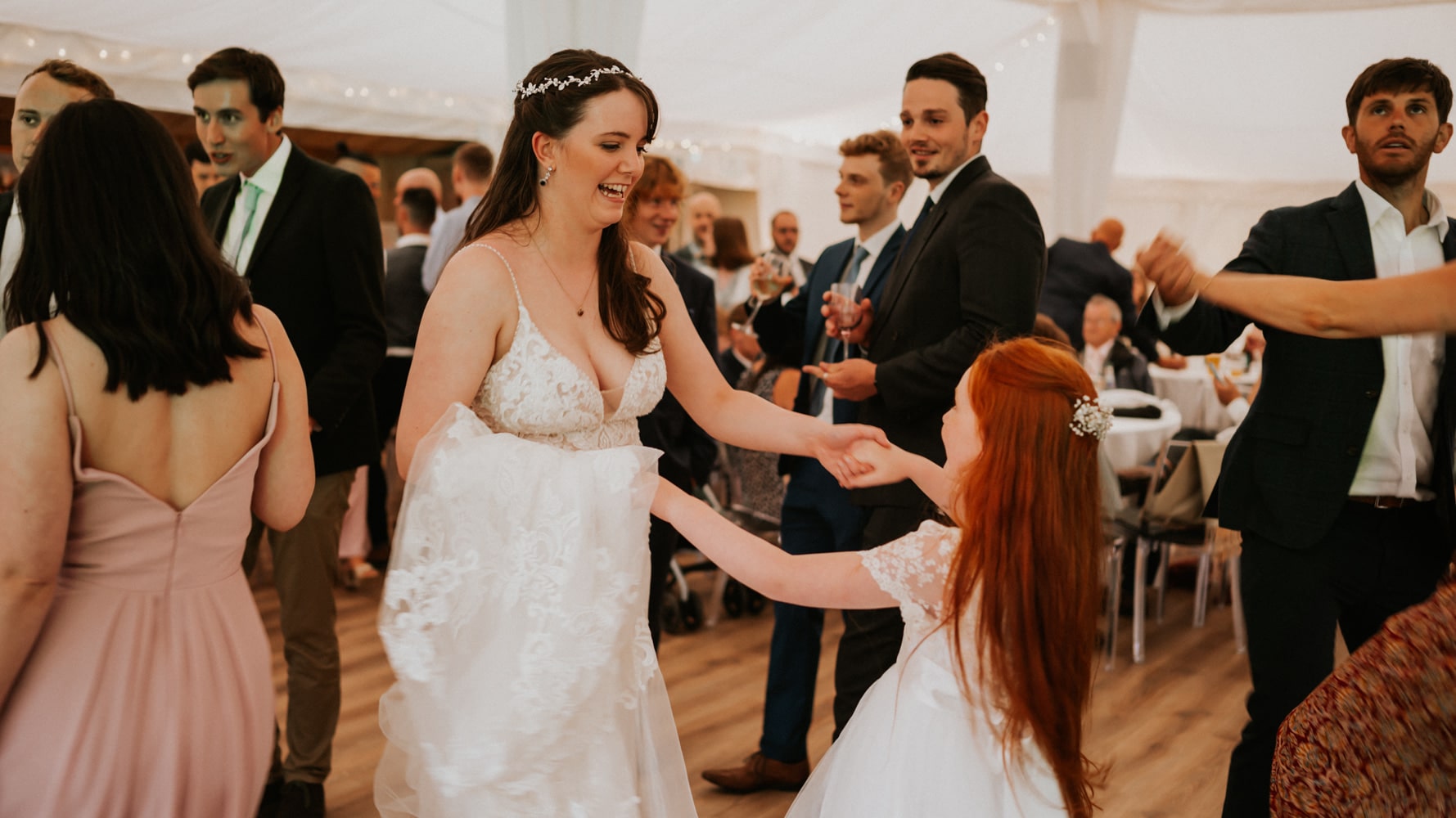 Bride dancing with flower girl