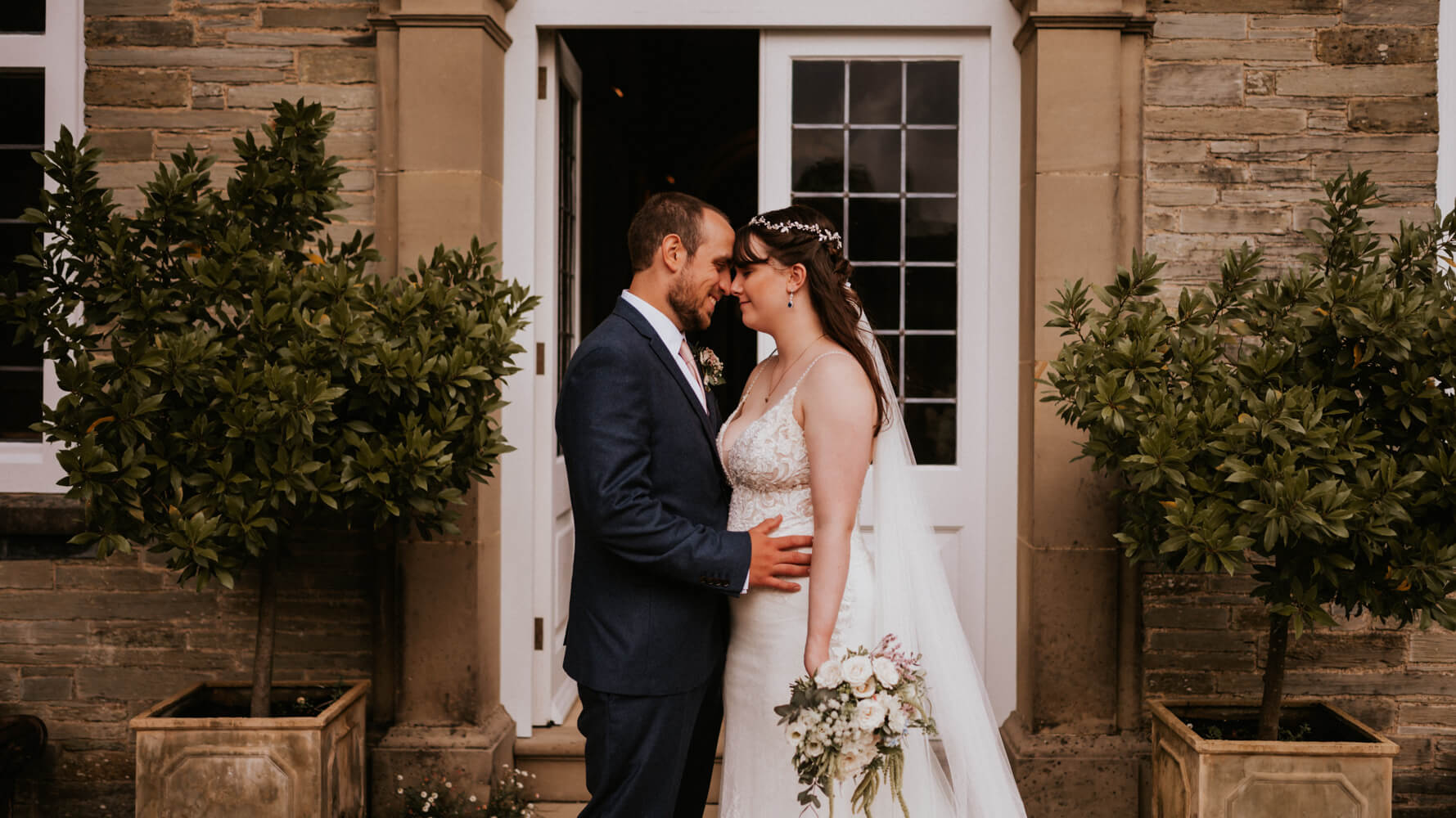 Lucy and Matt in front of wedding venue