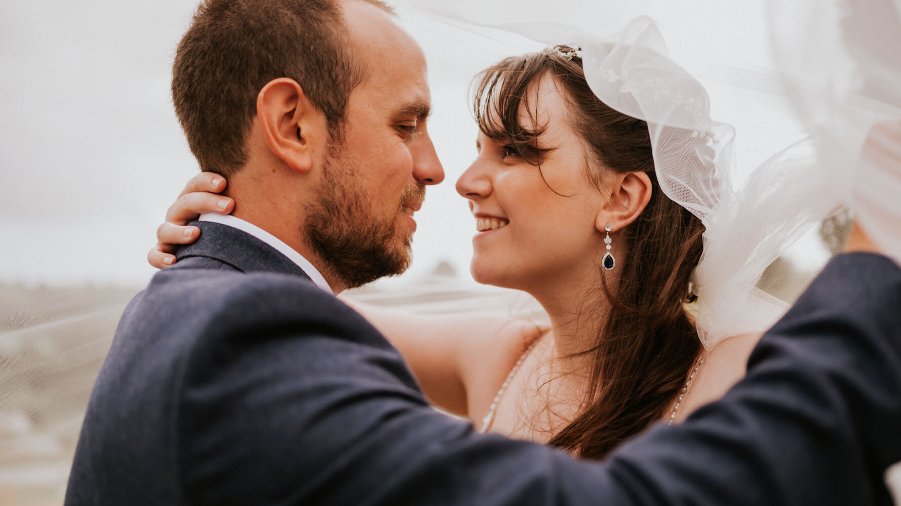 Newlyweds Lucy and Matt under veil