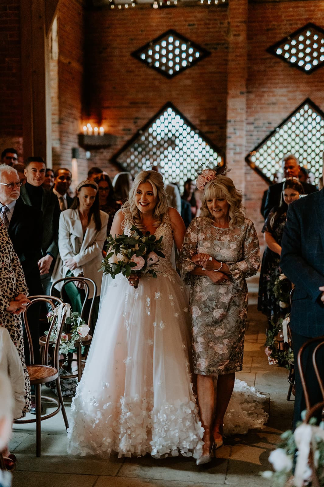 Bride walking up aisle with mother