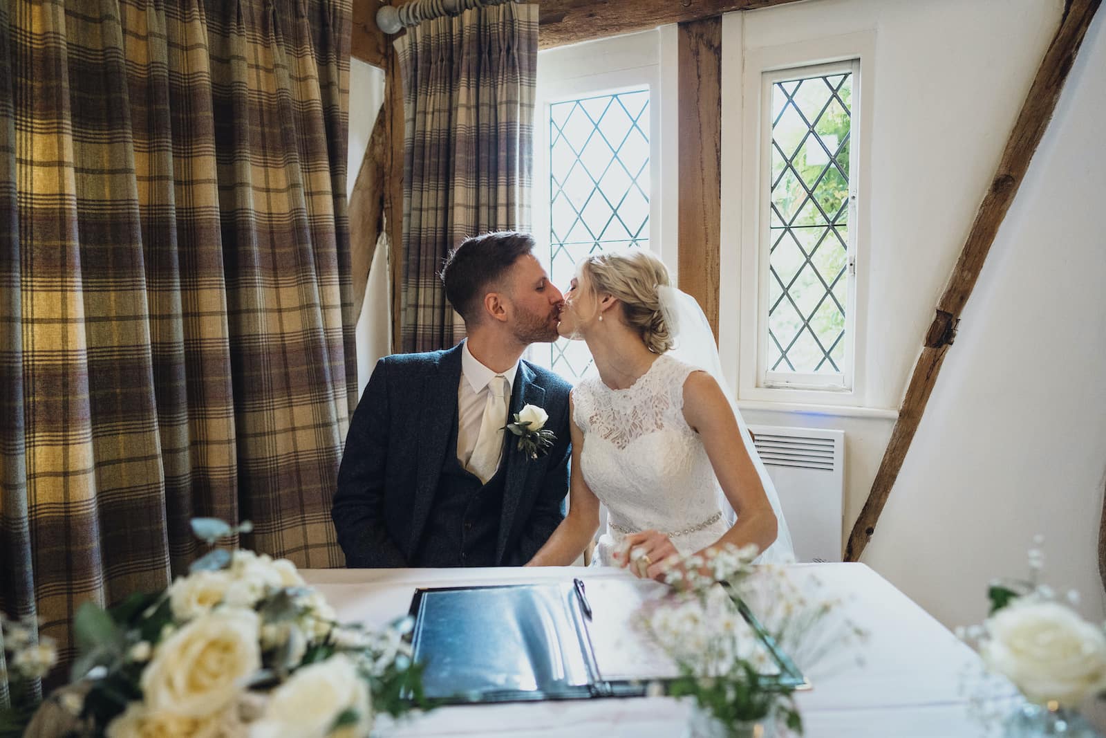 Bride and Groom kiss and sign register