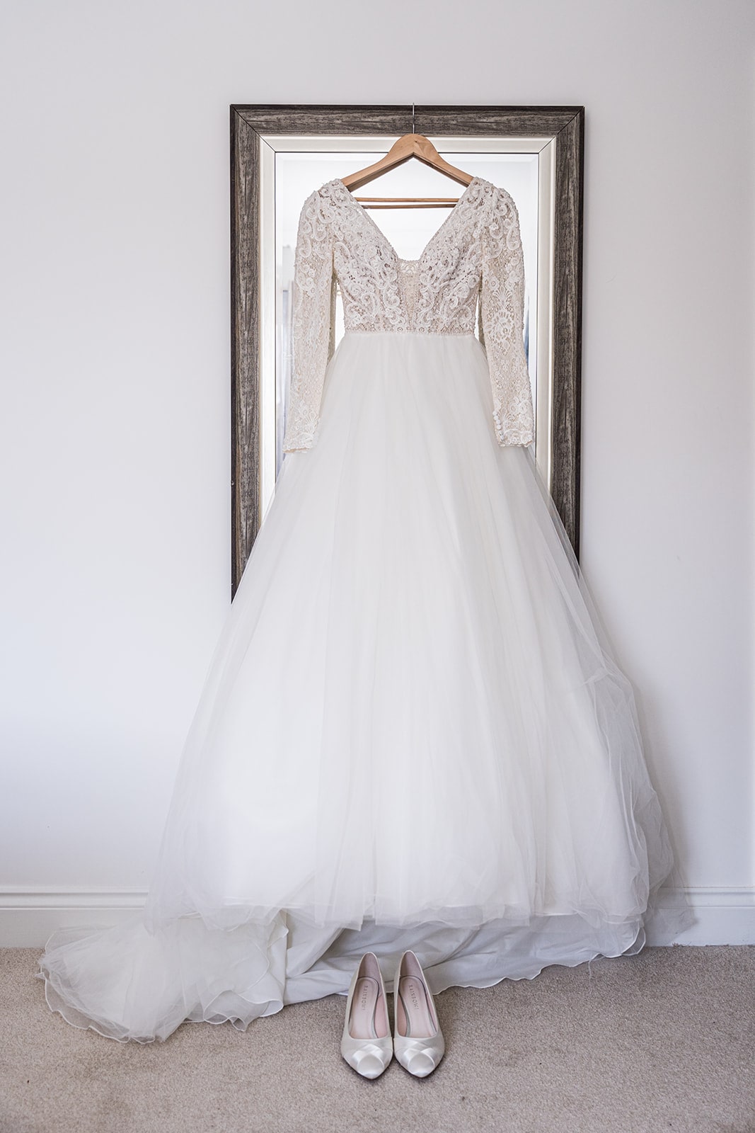 Wedding dress hanging on mirror