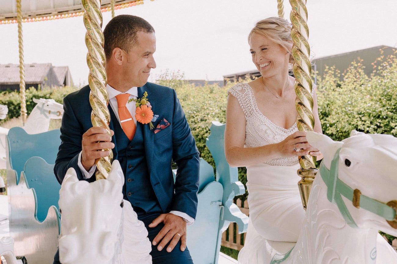 Bride and groom on carousel horses